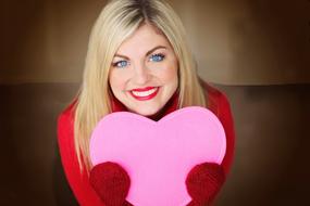 girl with a pink heart in her hands