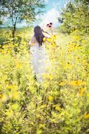 Pretty Woman on Wildflowers field at Summer