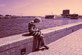 woman sitting on the pier in Amsterdam