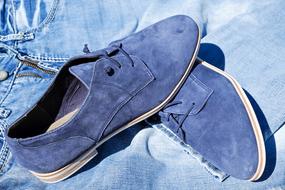 Blue suede shoes made of leather, on the jeans