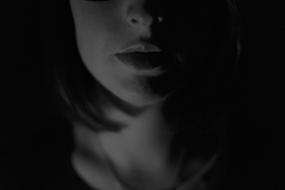 female face with sensual Mouth at darkness