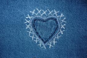Beautiful, white and blue heart, with the pattern, on the jeans