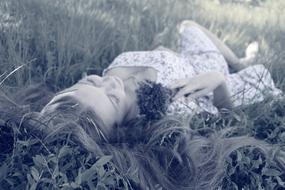 young Woman Sleeping on Grass