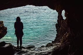 Silhouette of a woman in beautiful Cavo Greko, looking on the beautiful, turquoise sea, on Cyprus, Greece