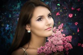 beautiful woman posing among pink flowers
