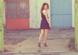 girl in a short dress among the buildings
