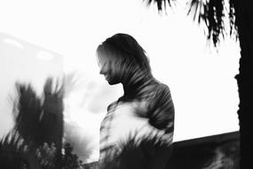 monochrome photo of woman and leaves