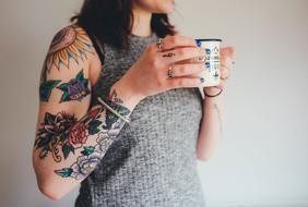 tattooed woman with coffee