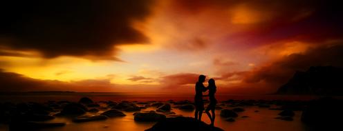 hugging couple at sunset