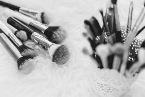 black and white blur picture of makeup brushes