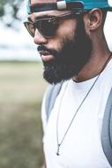cool bearded african american man in dark glasses