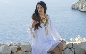 girl in white on the seaside on a clear day