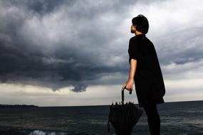 woman with umbrella on beach