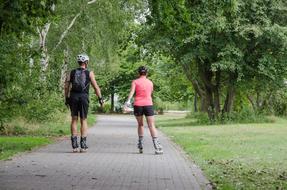 couple rollerblading in the park