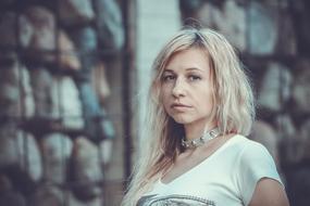 Portrait of the blonde woman with the necklace, in the park