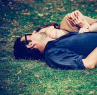 young Couple resting on Grass