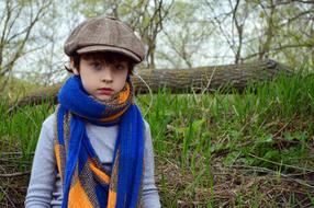 cute child boy wearing cap and scarf outdoor