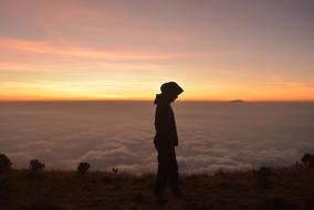 woman in hijab in mountains at dusk