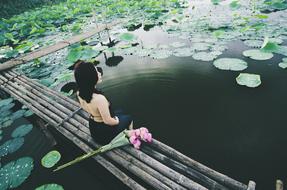 Woman Sitting on Pond pier