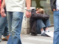 homeless woman begs for alms