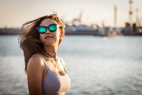 beautiful girl in sunglasses on the seashore