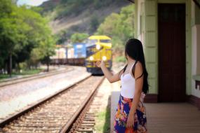 young Woman looking at Train