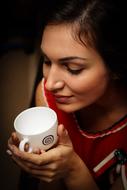 young Woman holds white empty cup