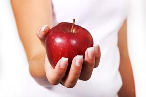 red apple in girl's hand