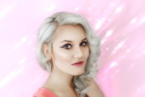 portrait of pretty blonde Woman at pink background
