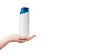 a bottle of shampoo on a human hand