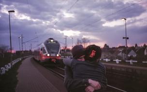 couple on a railway platform at dusk