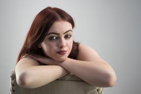 photo of a girl with dark hair on a chair