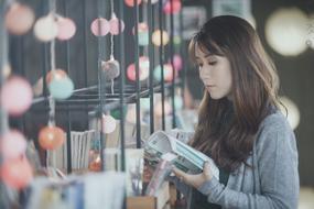 Asian girl, in the store, with the colorful lights, in Vietnam