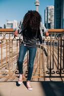 happy girl in jeans on the bridge on a sunny day