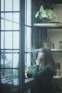 young Asian girl at open window