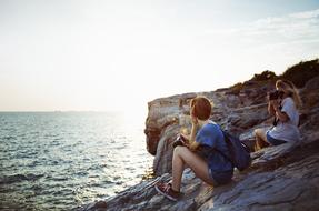 two resting girls on the shore