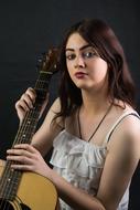 woman posing with guitar