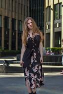 stylish girl in long dress on Street in Center of City