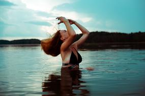 the girl in the water with her head thrown back