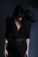 brunette Woman in black clothing looking down