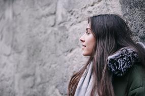 portrait of a young woman leaned on the wall