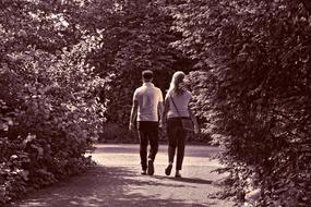 black and white photo of husband and wife walking in the park
