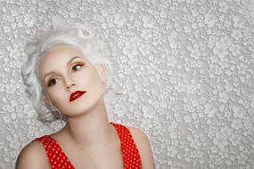 young girl with white hair at grey wall