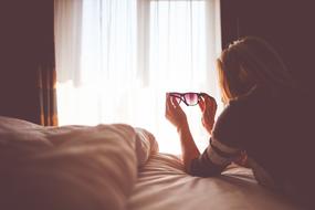 Lady with sunglasses in Bedroom