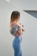 photo of a girl in jeans and with a fur cape
