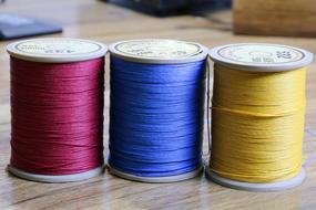 sewing threads for leather, three colorful bobbins