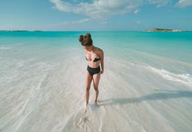 photo of a girl in a bikini on the turquoise ocean beach