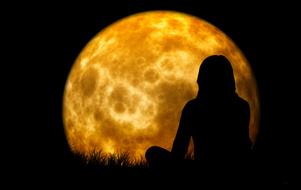 silhouette of a woman on the moon background
