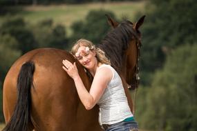 girl pressed against the horse