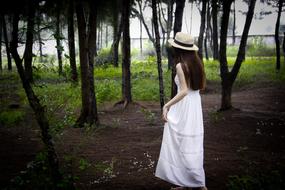 photo of a girl in a long white dress in the park